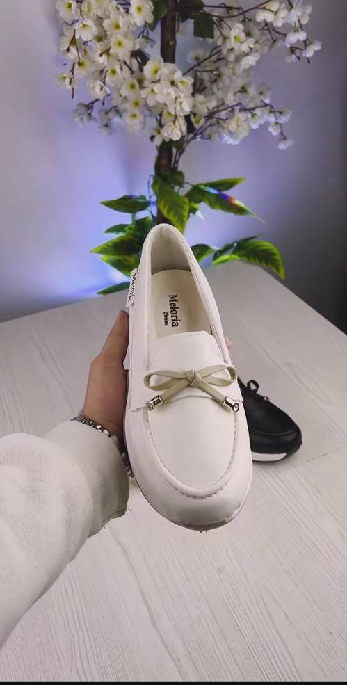 ActoStore white loafer held in hand